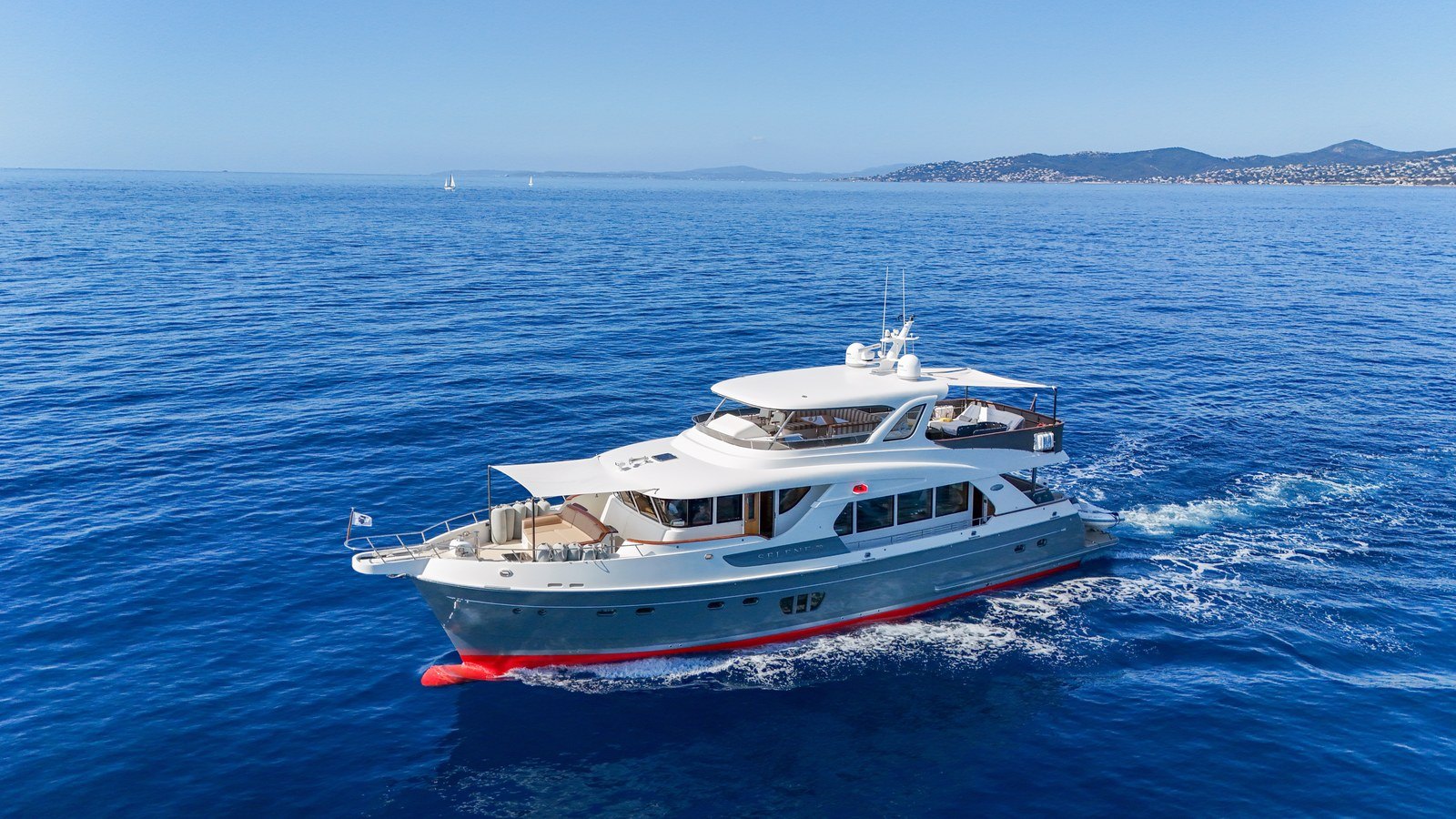 Sedna, a 23 m Selene 72 explorer for sale, under way with the coast behind her