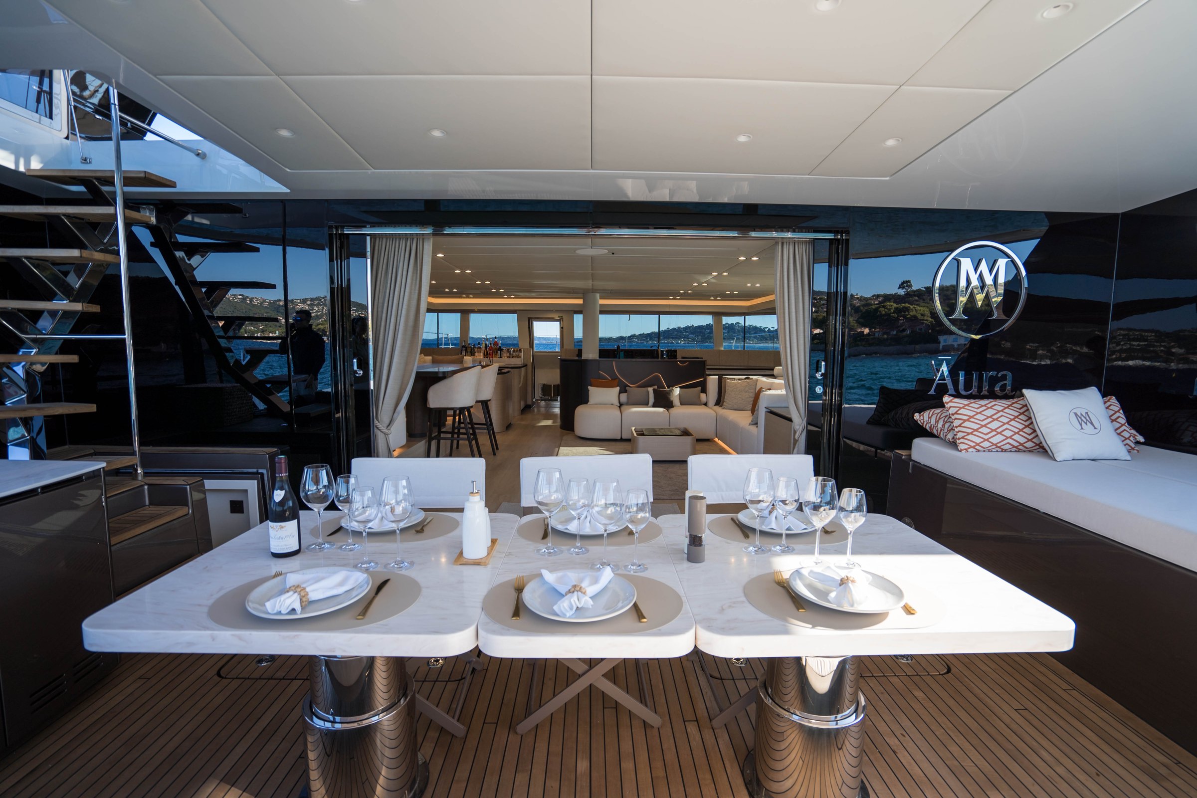 The table laid in the aft cockpit of Āura, facing the open main saloon